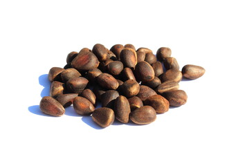 A bunch of pine nuts on a white background.