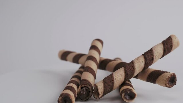 Chocolate wafer sticks or rolls, on a white background. Close-up.