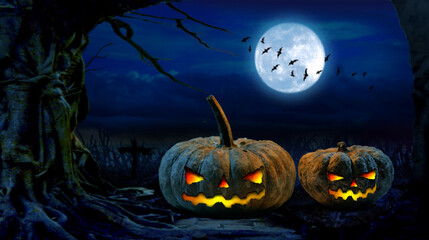 Halloween pumpkins on the ground Halloween background at forest night with moon.