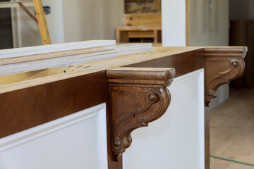 A new kitchen island with wooden corbels has been installed so granite countertops can be installed on it with new home © ungvar