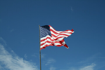American Flag waving against blue sky
