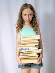 sad teenage girl holding a big stack of old books, sad girl with books