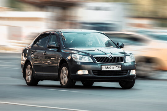 Fast moving car Skoda Octavia on the city road. Black sedan rides on street. Used auto in fast motion with blurred background. speeding in the city concept