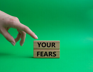 Your fears symbol. Wooden blocks with words Your fears. Beautiful gren background. Businessman hand. Business and Your fears concept. Copy space.