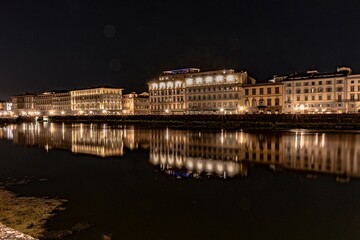 Night view of Florence with the Arno river in the foreground