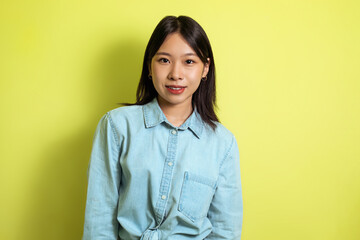 Portrait Of Attractive Japanese Young Woman Standing Over Yellow Background