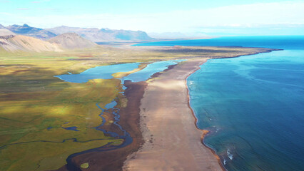 Fototapeta na wymiar Icelandic landscape of mountains, grass and sea.