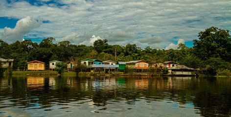 houses near the amazonia river at mamiraua reserve, brazil