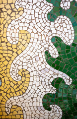 Detail of a beautiful abstract decoration of a building decorated with wave-shaped ceramic mosaics. Venetian mosaic as a decorative background. Mosaic ceramic stones for decorating pool walls.