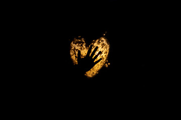 silhouette of woman hand on lighten heart symbol