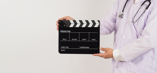 Doctor's holding Black Clapper board in hand on white background. Studio shooting.