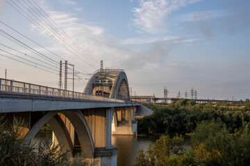 Freight train rides on the railway bridge. Industrial Zone.
