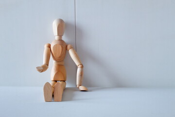 Concept of loneliness, poverty and abandonment with a wooden doll asking as a model	