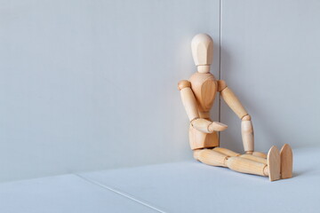 Concept of loneliness, poverty and abandonment with a wooden doll asking as a model	