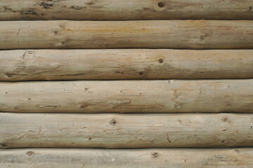 a wall made of a round wooden beam