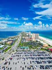 Vertical aerial cityscape view of modern buildings and roads with the beautiful Pensacola beach