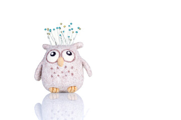 pincushion in the form of an owl on a white background
