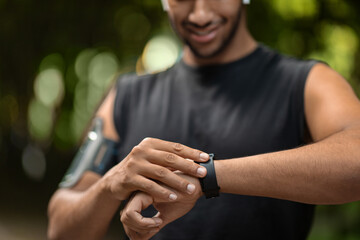 Cropped of black sportsman set his fitness tracker