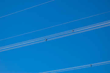 Fototapeta premium a high-voltage power transmission line, in the photo, a power line support against a blue sky