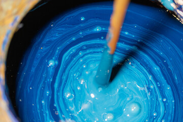 Mixing up old blue paint with drill