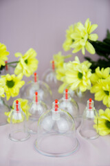 Vacuum jars for hijama and yellow flowers, bloodletting, oriental medicine, Arabic healer, anti cellulite therapy, treatment.