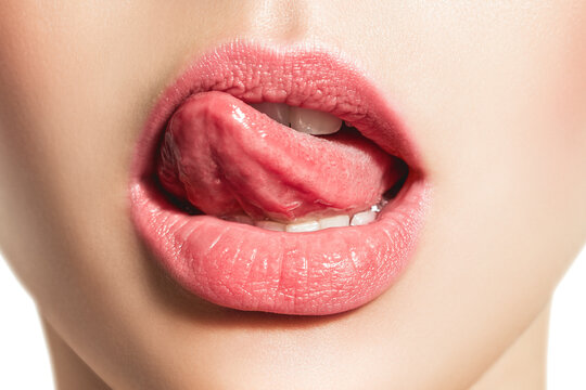 Woman's tongue seductively licking lips. Beautiful chubby lips. seduction concept.