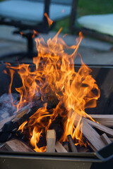 Fire burning kindling in a patio fire pit in the evening