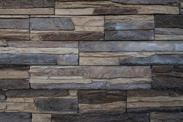 Artificial stone brick wall with the look of pressed together flat stones