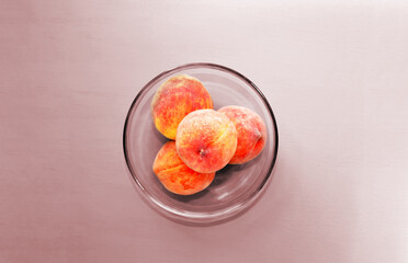 ripe peaches on a pink background