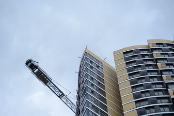 modern buildings against the background of a cloudy sky, a green new building a large number of windows, entire buildings in Ukraine, the top angle of the photo