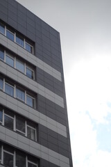 modern buildings against the background of a cloudy sky, a green new building a large number of windows, entire buildings in Ukraine, the top angle of the photo