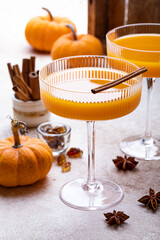Halloween, Thanksgiving or fall cocktail pumpkin martini, homemade festive seasonal drink pumpkintini with cinnamon