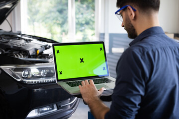 Car Service Mechanic is Running Diagnostics Software on an Advanced Computer with Green Screen Mock...
