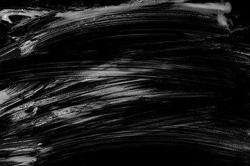 Soap foam spread with bubbles isolated on black texture, top view