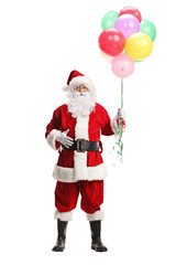 Full length portrait of santa claus holding a bunch of colorful balloons