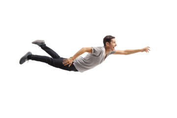 Casual young man flying and reaching for something