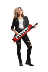 Young female musician playing a keytar synthesizer - obrazy, fototapety, plakaty
