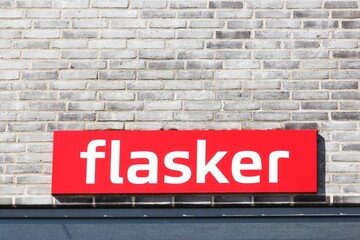 Flasker sign on a wall in Denmark called bottles in Danish language. The reusable container deposit system consists of plastic and glass bottles that once purchased are reusable