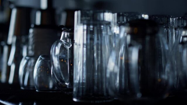 Bartender clean cocktail glasses for various drinks closeup. No people pub