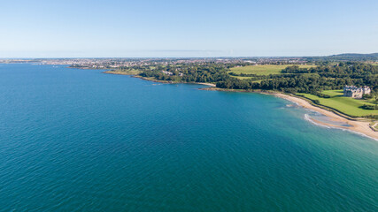 Aerial view on beach and coast of see in Helen's Bay, Northern Ireland. Drone shot sunny day 