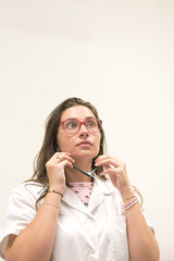 Hearing aid dispenser putting on a stethoscope.