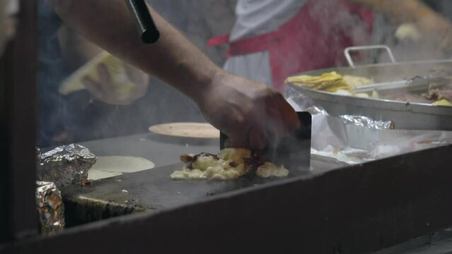 Open air Mexican taqueria Street food Restaurant Where two Mexicans are making tacos and quesadillas