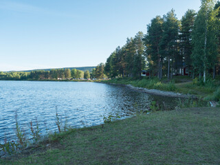 summer view of Lille Lulealven river at Arctic Camp Jokkmokk ,blue sky white clouds