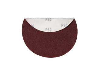 Round sandpaper of red color with a folded part on which you can see the mark of the value for sandpaper granulations.