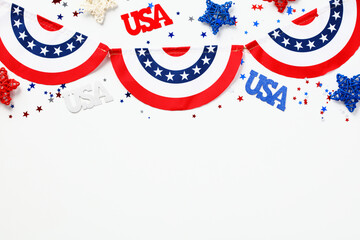 USA holiday celebration concept. American flag colors garland and USA decorations on white background. Flat lay, top view.