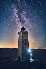 Old Lighthouse and Milky Way in northern Denmark. High quality photo - obrazy, fototapety, plakaty