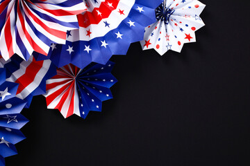 Red white and blue paper fans on black background. USA patriotic decorations for party. Happy...
