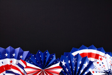 American Independence Day paper fans on black background, Themed party decorations top view. Happy...