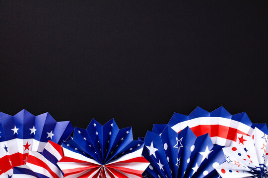 American Independence Day paper fans on black background, Themed party decorations top view. Happy 4th of July, Labor Day, Presidents Day concept.