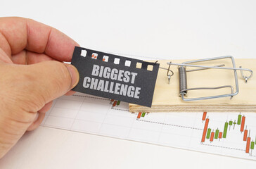 Fototapeta premium On the quote chart there is a mousetrap from which the hand takes out a sign with the inscription - Biggest Challenge